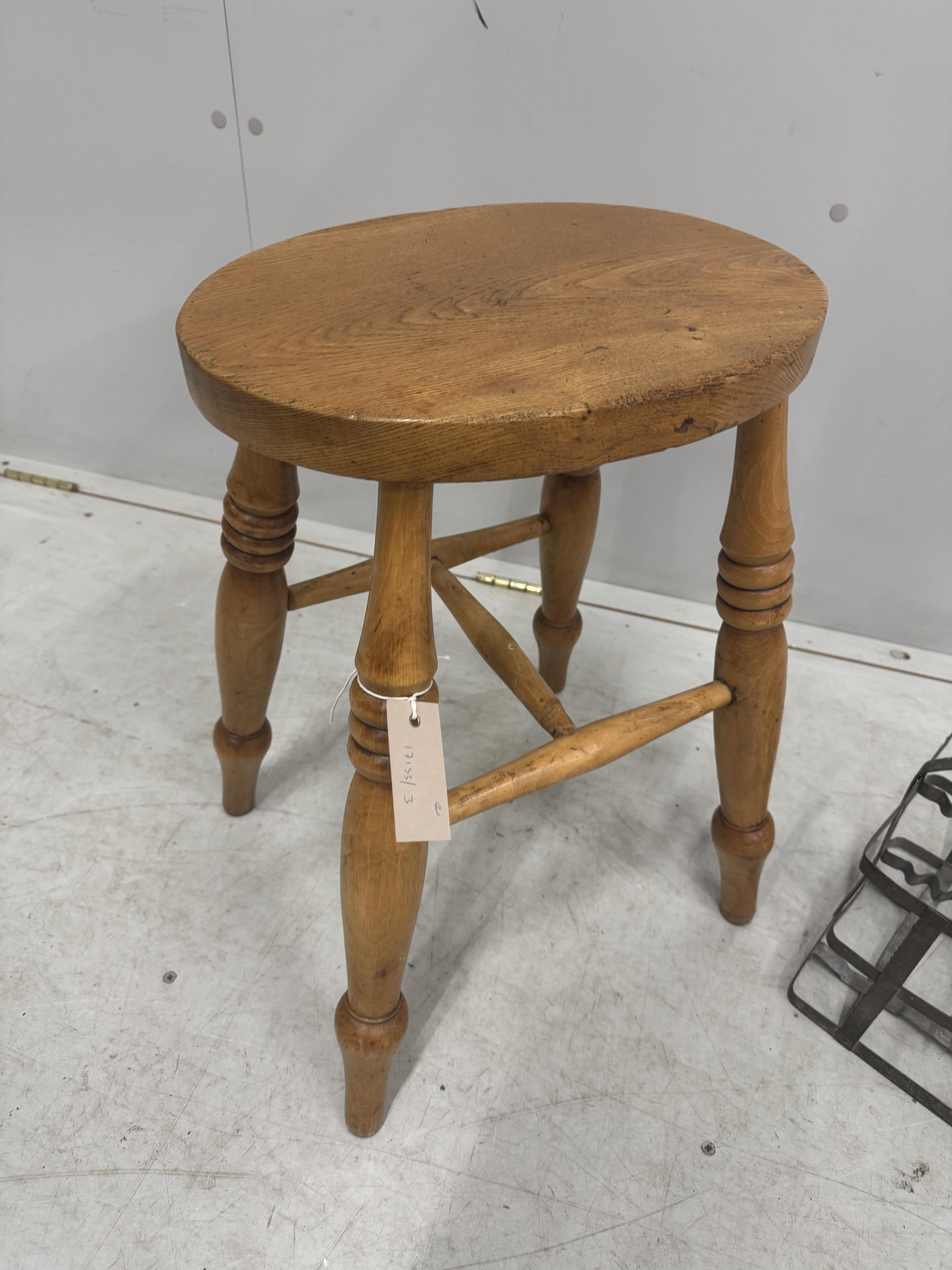 A Victorian elm and beech stool, height 52cm, together with a French galvanised six section bottle carrier. Condition - fair to good